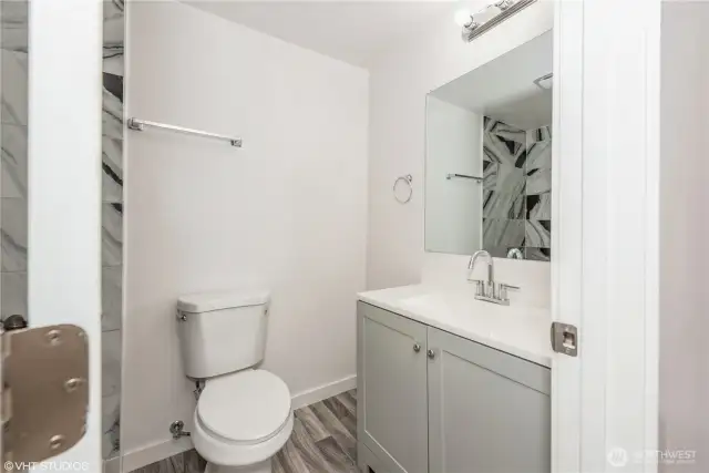 The primary bathroom features a shower designed for easy access and safety, ideal for comfort and convenience.
