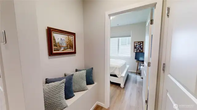 Entry from garage has a built-in bench, showing entry to main level bedroom.