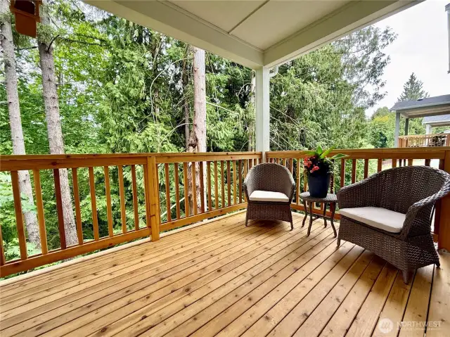 Cedar deck off of kitchen eating area looking on to true greenbelt.