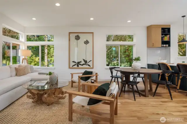 Upstairs, the open-concept main level features soaring 9-foot ceilings, a chef’s kitchen with quartz slab peninsula, locally made Belmont soft-close cabinetry, GE Profile induction range, a rare walk-in pantry, and Delta designer fixtures throughout.