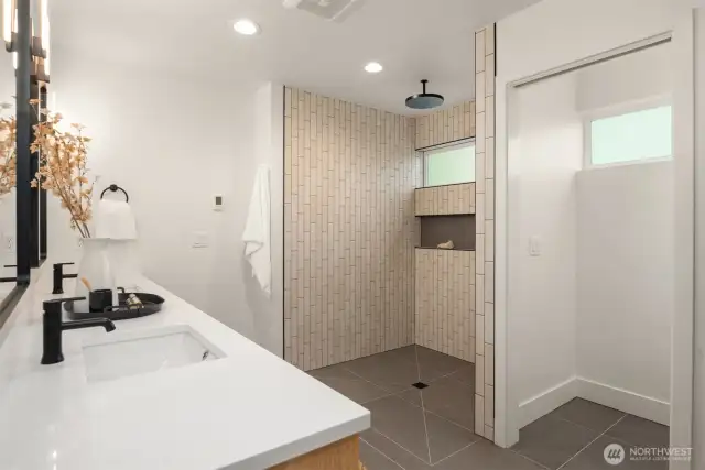 The top-floor primary suite offers Sound views, a walk-in closet, and a spa-like bathroom with a curbless shower and heated floors—even inside the shower!