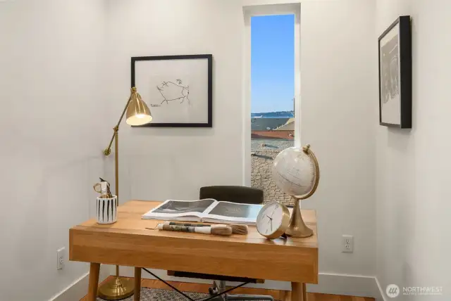A small office nook with Sound views adds function without sacrificing flow, and a laundry closet on the same level as the primary suite makes daily life even easier.
