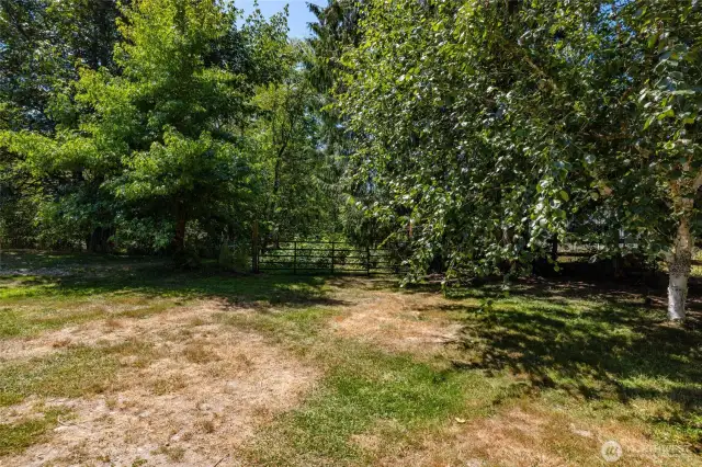 Another gate leads down a path into the wooded part of the property with pond and stream