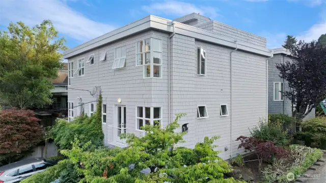 This beautiful Magnolia townhome is situated on a quiet corner with green space and a walking path across the street.