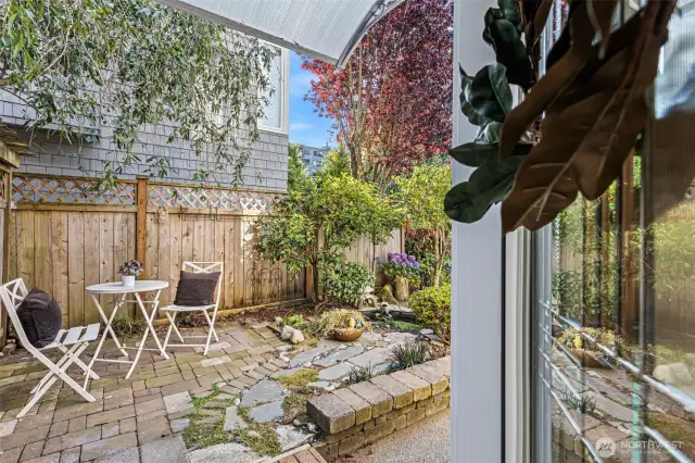 The professionally landscaped front yard welcomes you in with reflective pond and Flagstone patio.