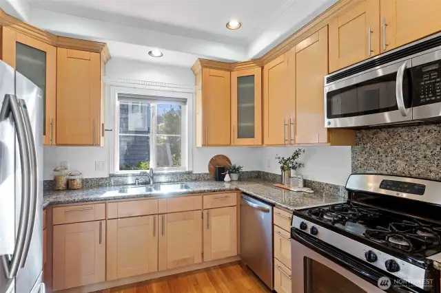 The kitchen features stainless steel appliances including a gas range and brand-new dishwasher.