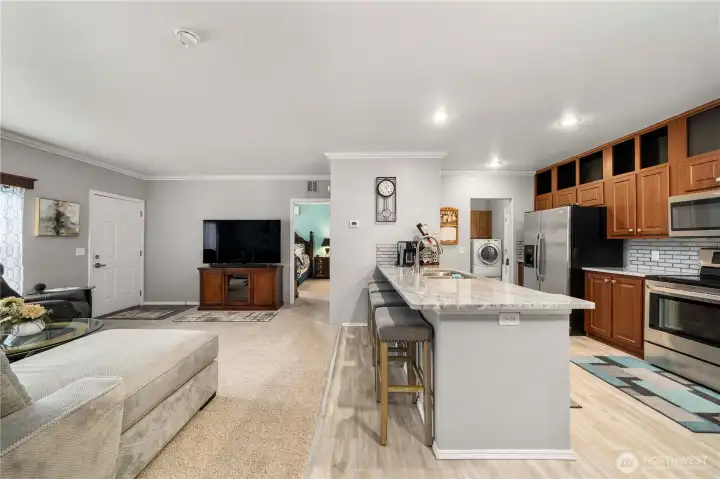 The open kitchen feels spacious and easy to move through, with plenty of counter space for cooking, baking, or hosting casually.