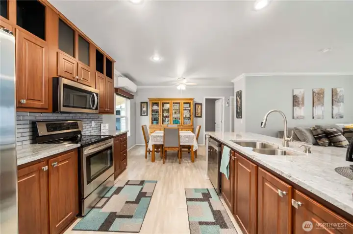 The kitchen features stainless steel appliances, tons of storage, and a walk-in pantry, all flowing easily into the dining and living areas for everyday living.