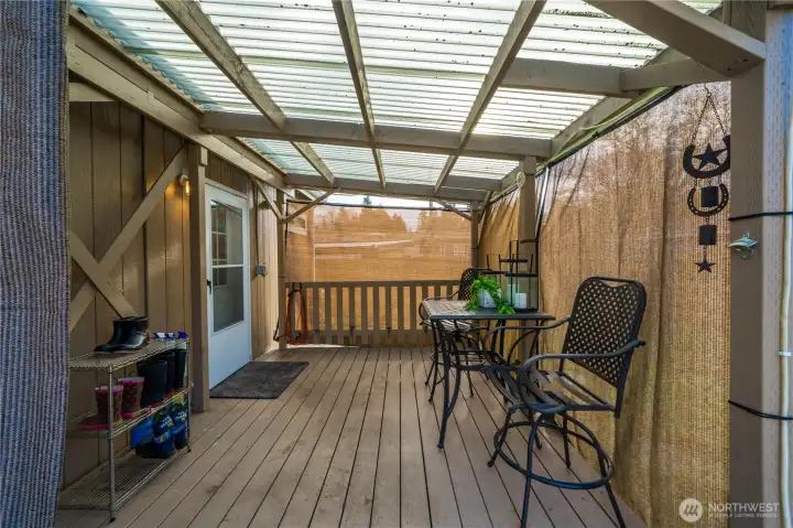 The covered deck creates a comfortable outdoor spot to relax, dine, or enjoy the fresh air no matter the season.