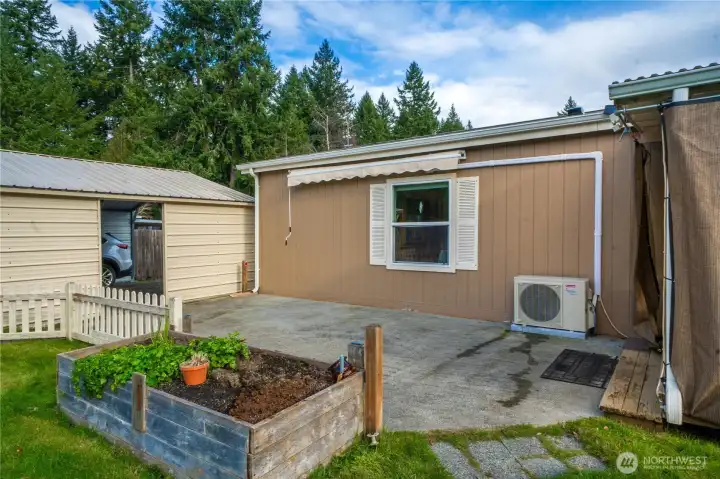 A paved patio and raised garden bed add functional outdoor space for gardening, hobbies, or easy everyday use.