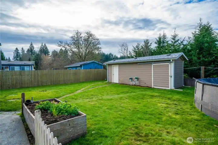 This angle highlights the open lawn and garden space, perfect for low-key outdoor time or tending to plants.