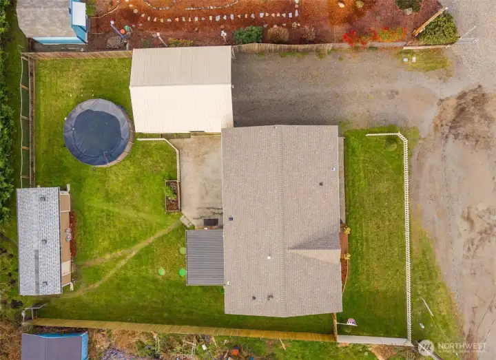 A bird’s-eye view ties the property together, highlighting the spacious lot, outdoor areas, and a NEW ROOF for added peace of mind.