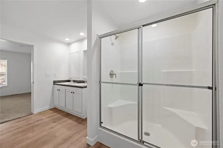 Spacious shower in light filled primary bathroom