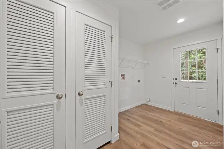 Large utility room off kitchen/dining area with door that leads to back deck,