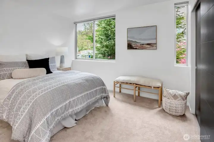 Generously sized guest bedroom with abundant natural light