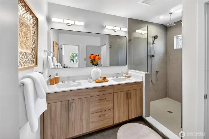 Primary bath with dual sinks, walk-in shower, heated tile floors and seperate water-closet *Photos are of model home - finishes vary