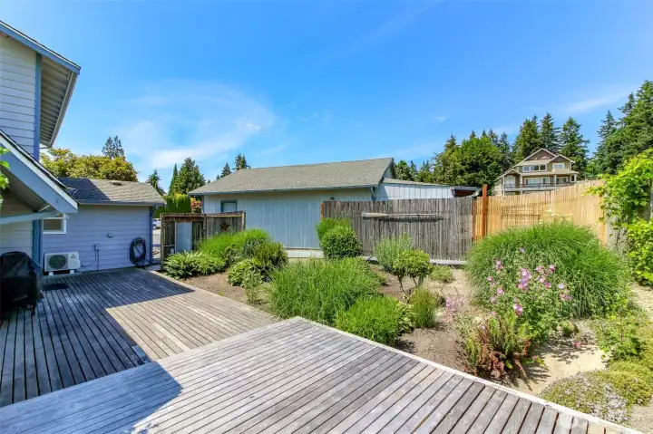 Over-sized back deck and rear flower garden.