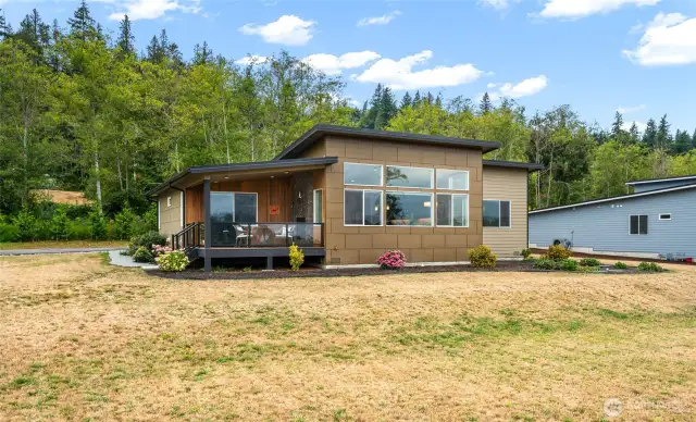 Rear of house that has a deck to open up to the views
