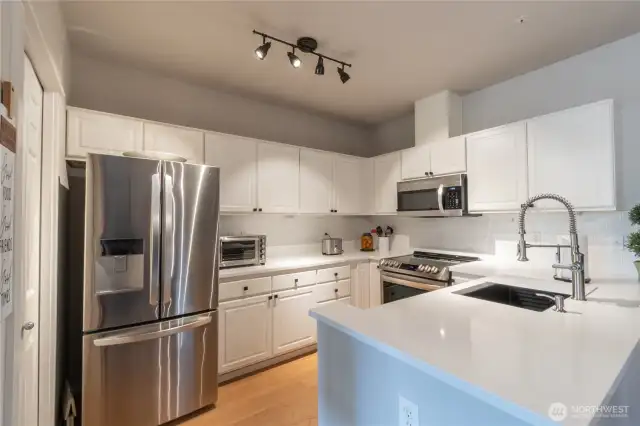 Beautifully updated kitchen featuring modern cabinetry, sleek countertops, and stainless steel appliances. Open and bright with ample storage and workspace, perfect for everyday living and entertaining.