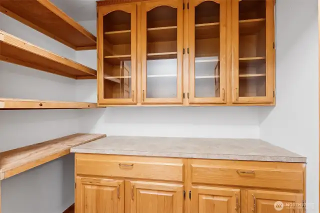 Updated cabinetry and shelving providing abundant extra storage.