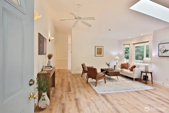 Let's go inside.... Freshly painted interior with new LVP flooring throughout the home. Straight ahead and to the right is your kitchen and to the left, the hallway that leads to bedrooms, bathrooms, the laundry room & garage.
