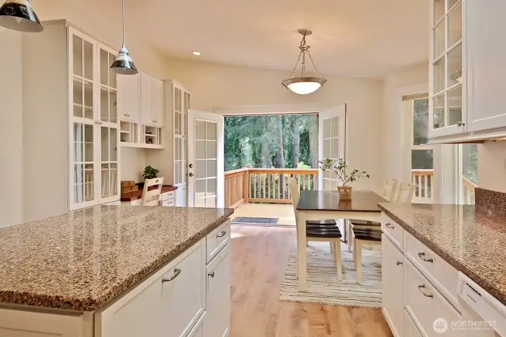 A favorite feature of this home is your connection to the nature that surrounds you. French doors open wide to the nearby trees and lovely landscape. Check out all the custom cabinetry!