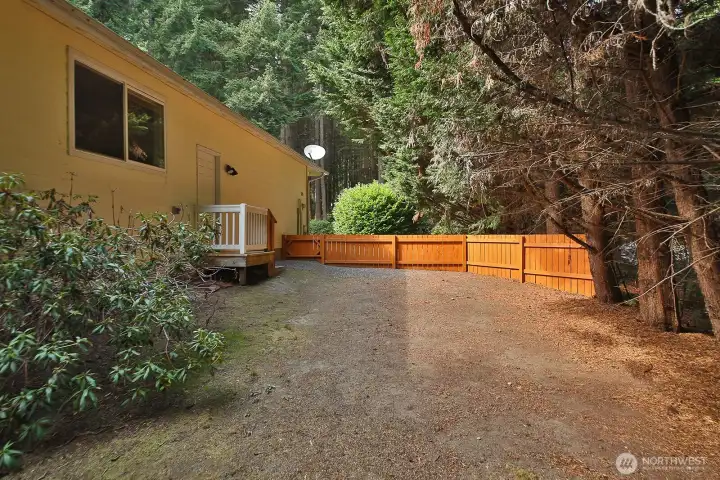This is the east side of your home and it is fenced. Door to the right is to the the utility room. Window before the door is to Bedroom #3 and window to Bedroom #2 is just beyond the left edge of this photo.