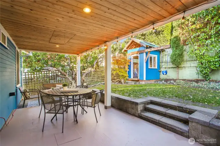 Covered deck. Play and garden space. Storage shed.