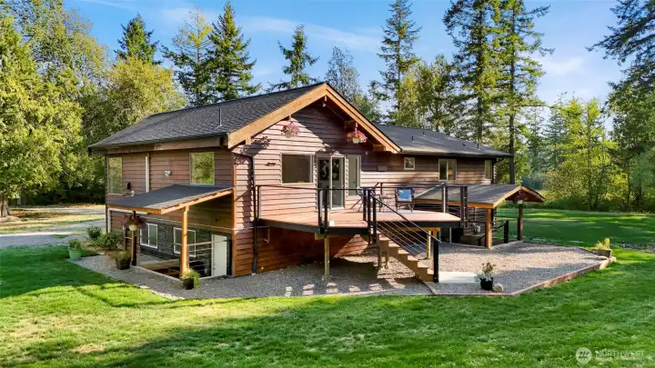 Back of the home.  To left and right entries to the lower level.  Very pleasant upper level deck is off of the ktichen and dining area.