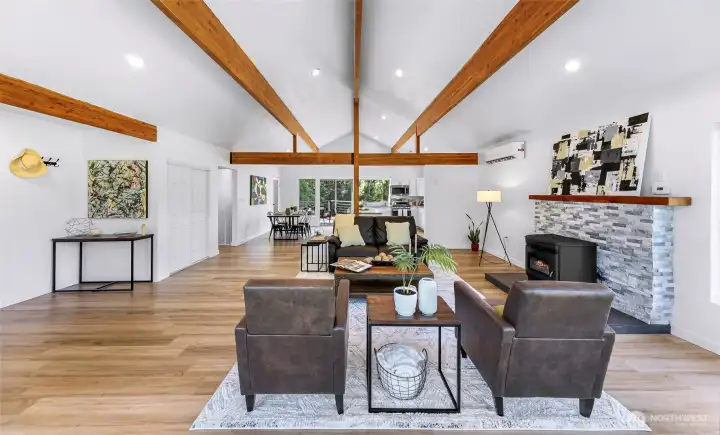 View from the front windows.  All vaulted over the living room, dining area and the kitchen. Three paintings in this staged area are originals by Kevin Hoover, a local artist with a gallery in Blaine.