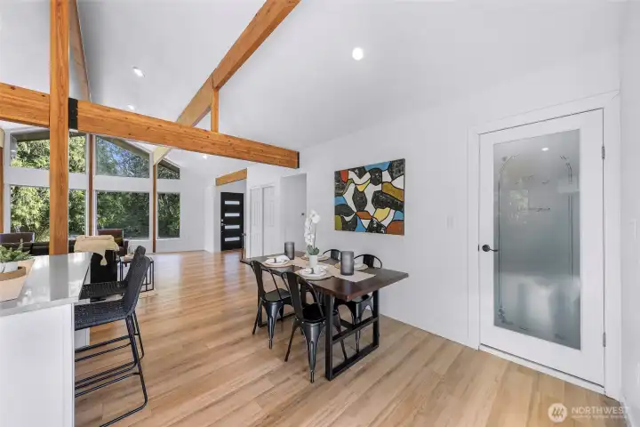 Walk-in pantry is just off of the kitchen and behind the dining area. Hallway in the middle leads to the lower level staircase and the rest of the upper level.