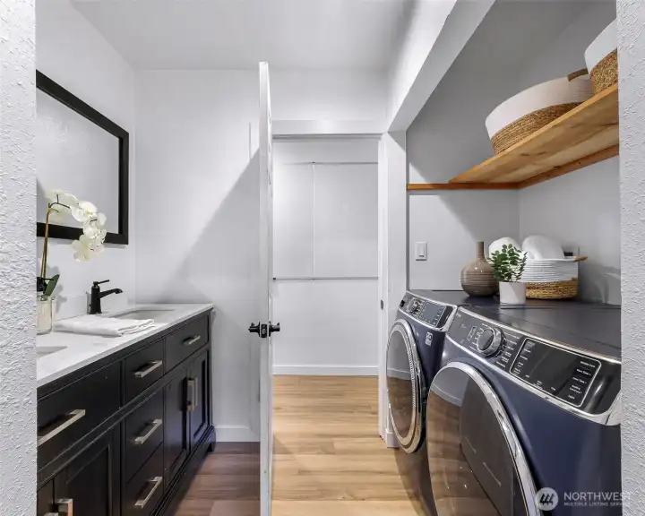 From hallway, second bath has two sinks and also accommodates the washer and dryer.
