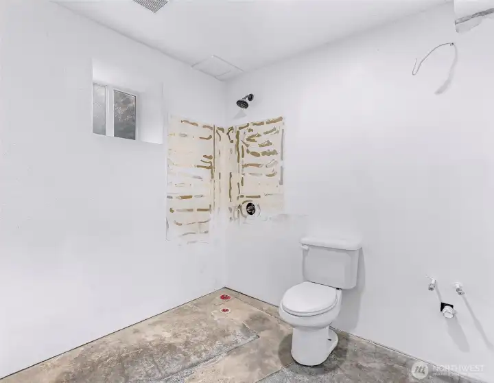 3/4 bath is ready to bring your design plans.  Shower straight ahead, sink with cabinetry to the right.