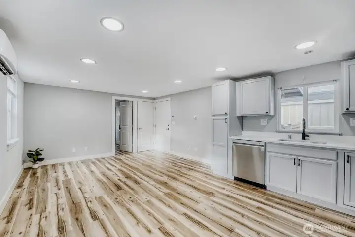 Washer and dryer are in the far corner behind the main entrance door.