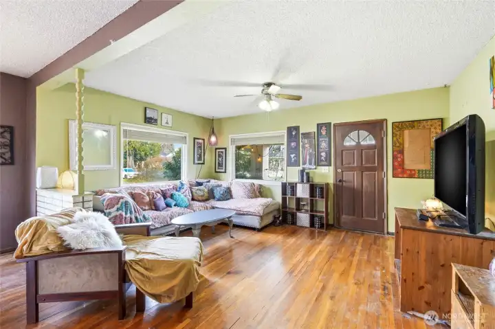 This flexible layout offers a seamless transition from the entry to the living room, complete with a ceiling fan and ample natural light.