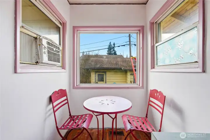 A dining nook is conveniently located adjacent to the kitchen for sipping morning coffee.