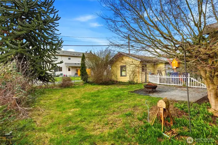 The spacious, partially-fenced backyard offers plenty of room for gardening and outdoor recreation in a private setting.