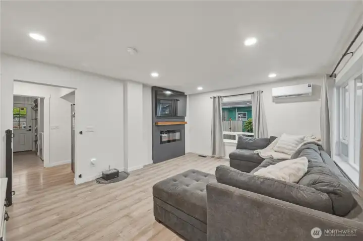 Living room looking into back hall which leads to kitchen dining area to right, laundry/mudroom straight ahead and secondary bed and bath to the left.