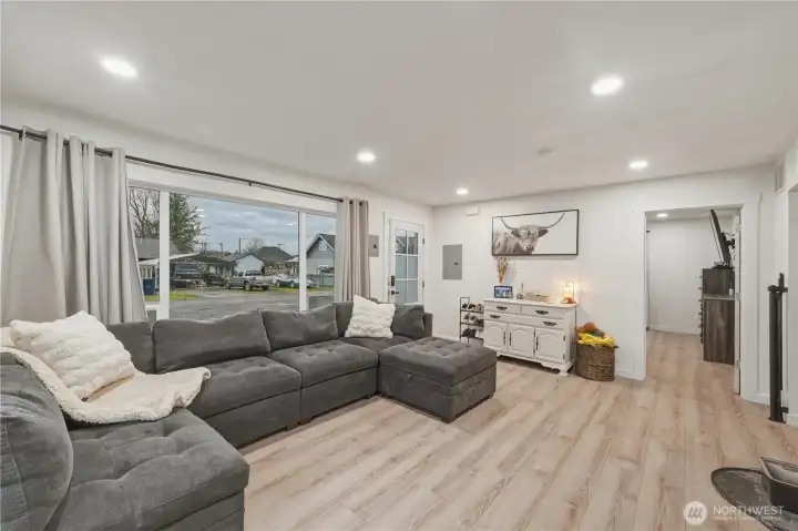 Large picture window looks out to street and brings in lots of light.  Primary bedroom is through door to right.