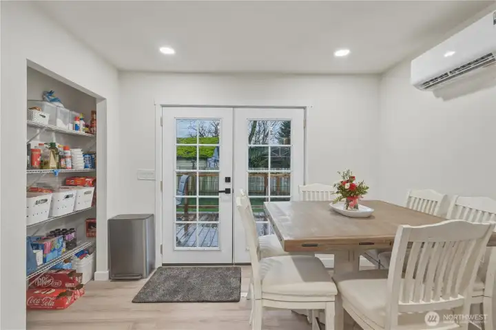 French doors out to new deck and fenced back yard.
