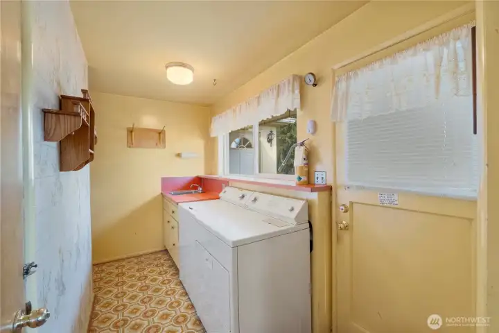 Laundry room with access to the deck and the basement