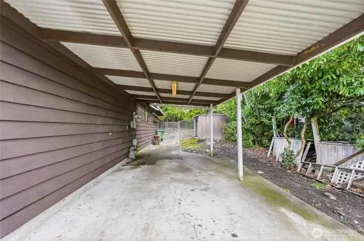 Attached carport adds more covered parking.  Shed in rear.