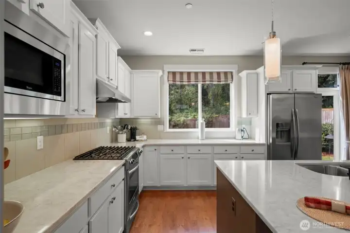 Kitchen overlooks sunny yard complete with Hummingbirds!