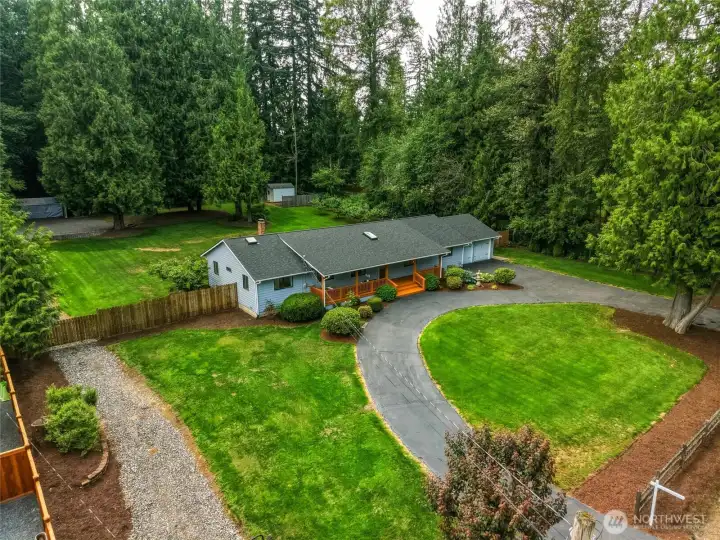 Circular driveway and manicured grounds create a welcoming first impression while providing ample guest parking.