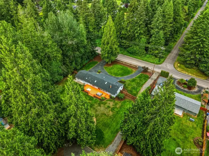Bird’s-eye view showcases the expansive backyard, oversized deck, and abundant usable outdoor space.