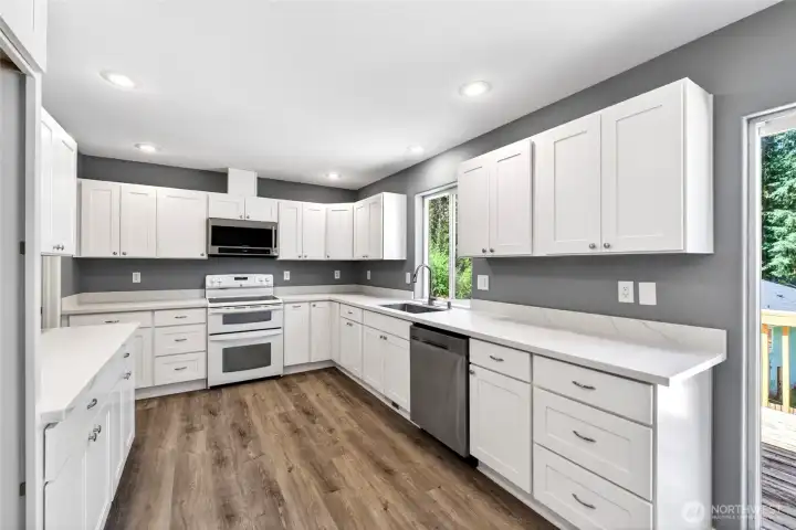 Almost brand new kitchen with new cabinets, quartz countertops. Walk in pantry to the left.