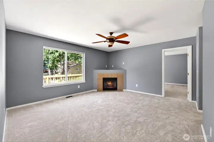 Family room with propane fireplace. Primary bedroom to the right.