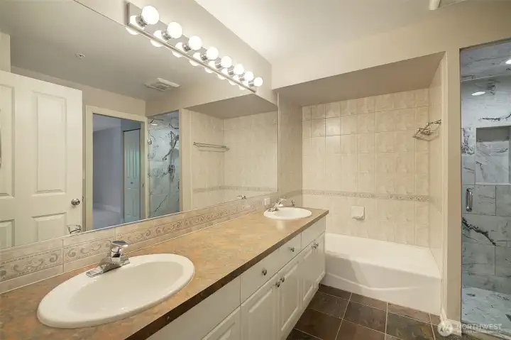 Bathroom has double sinks, tons of storage and a separate bath and shower.