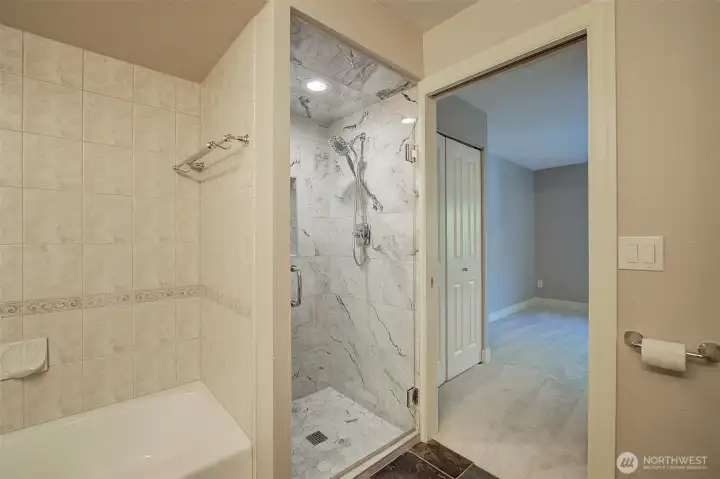 View from bathroom into bedroom. You can see one of two closets on your left after the shower.
