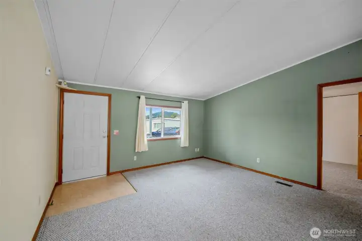 Living room at front door with door to Primary Bedroom Living room at front door with door to Primary Bedroom